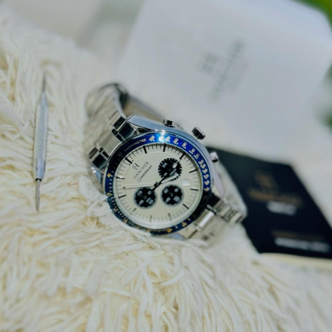 Silver watch with blue accents on a textured white surface